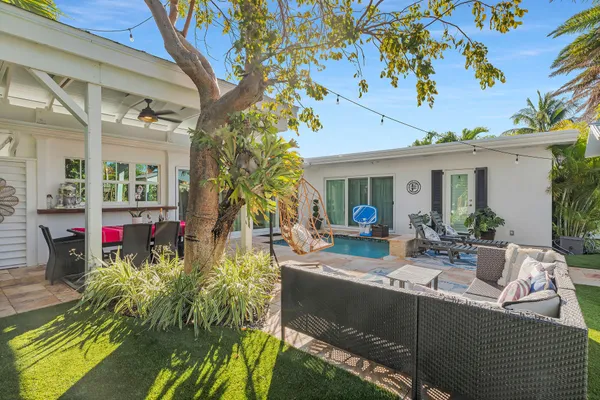 a view of a lake with boats and palm trees
