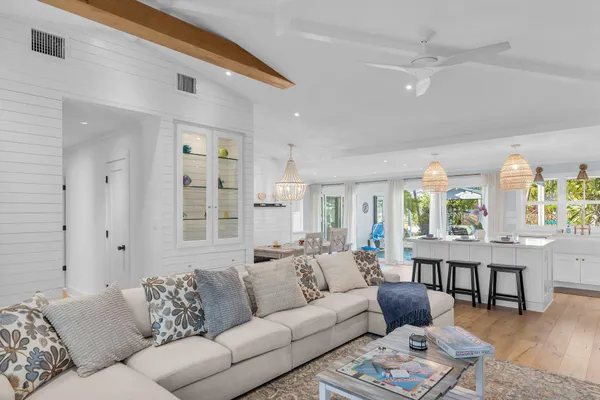 a living room with furniture wooden floor and a large window