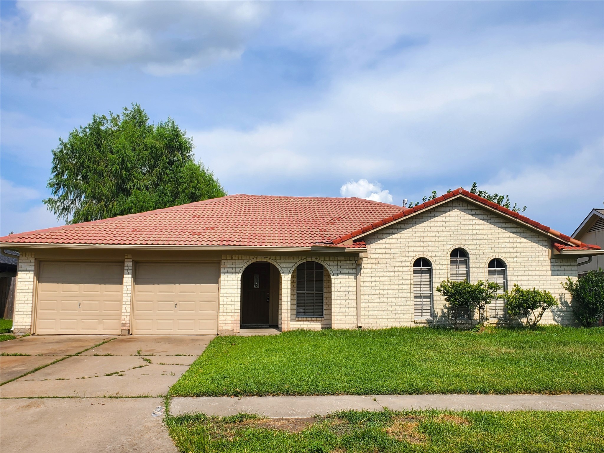 a front view of a house with a garden
