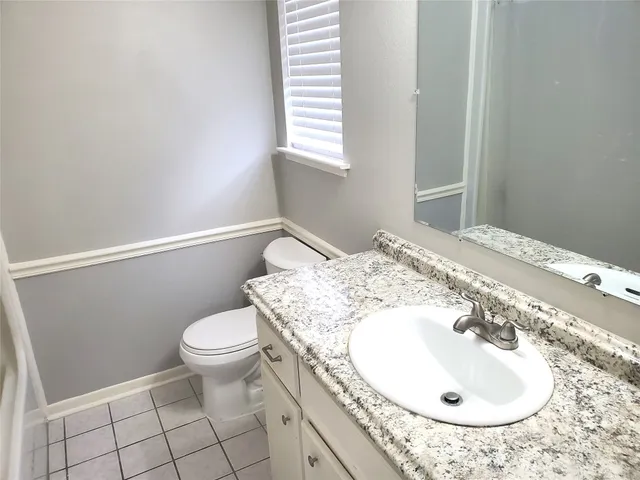 a bathroom with a sink toilet and a mirror