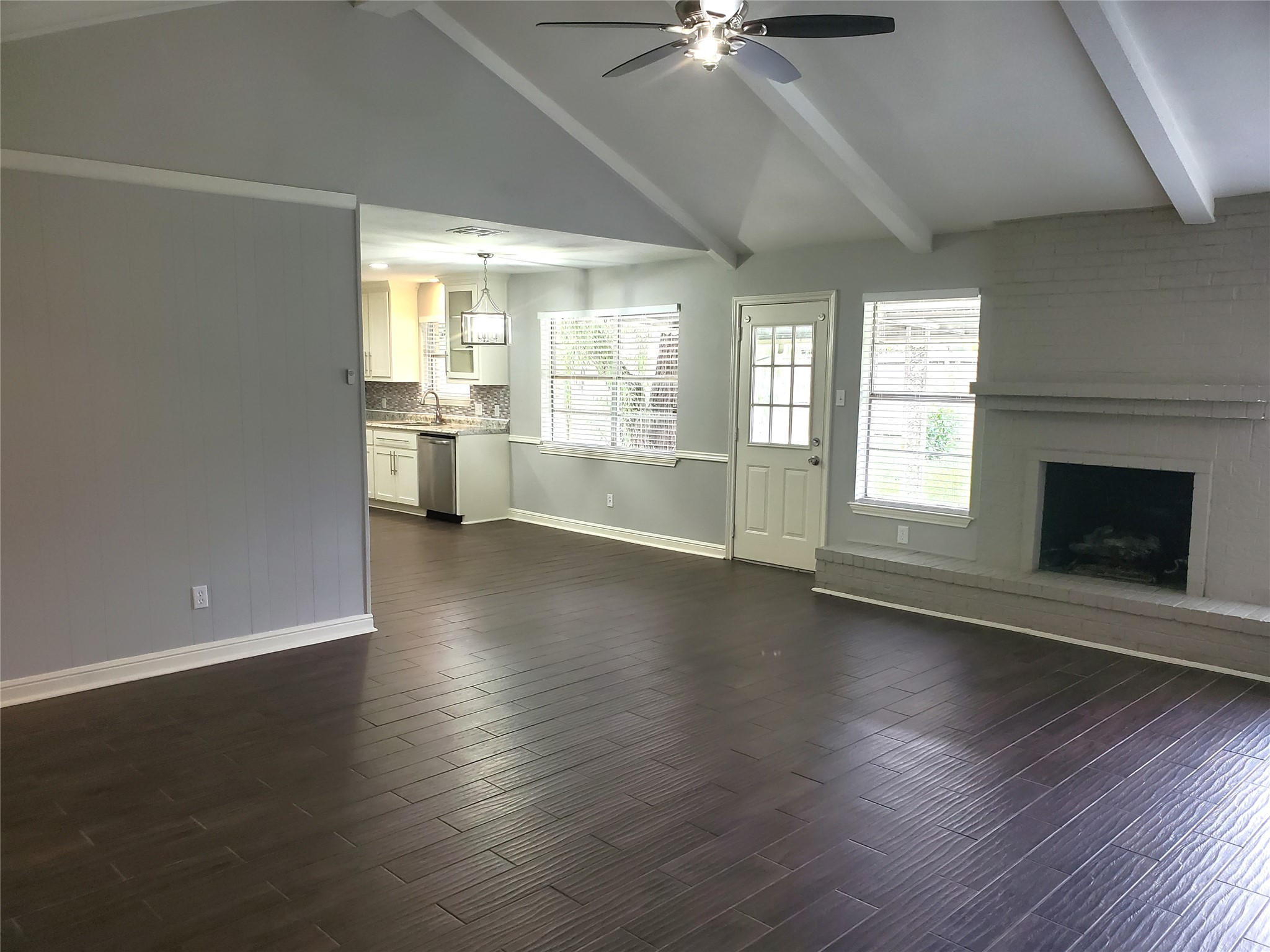 4507 Seneca Street Pasadena, TX 77504 - Photo 2 of 23 an empty room with wooden floor fireplace and windows