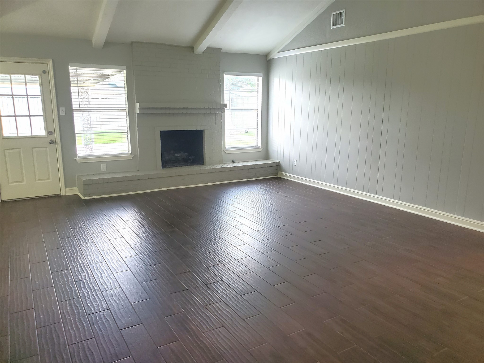 4507 Seneca Street Pasadena, TX 77504 - Photo 4 of 23 an empty room with wooden floor and windows