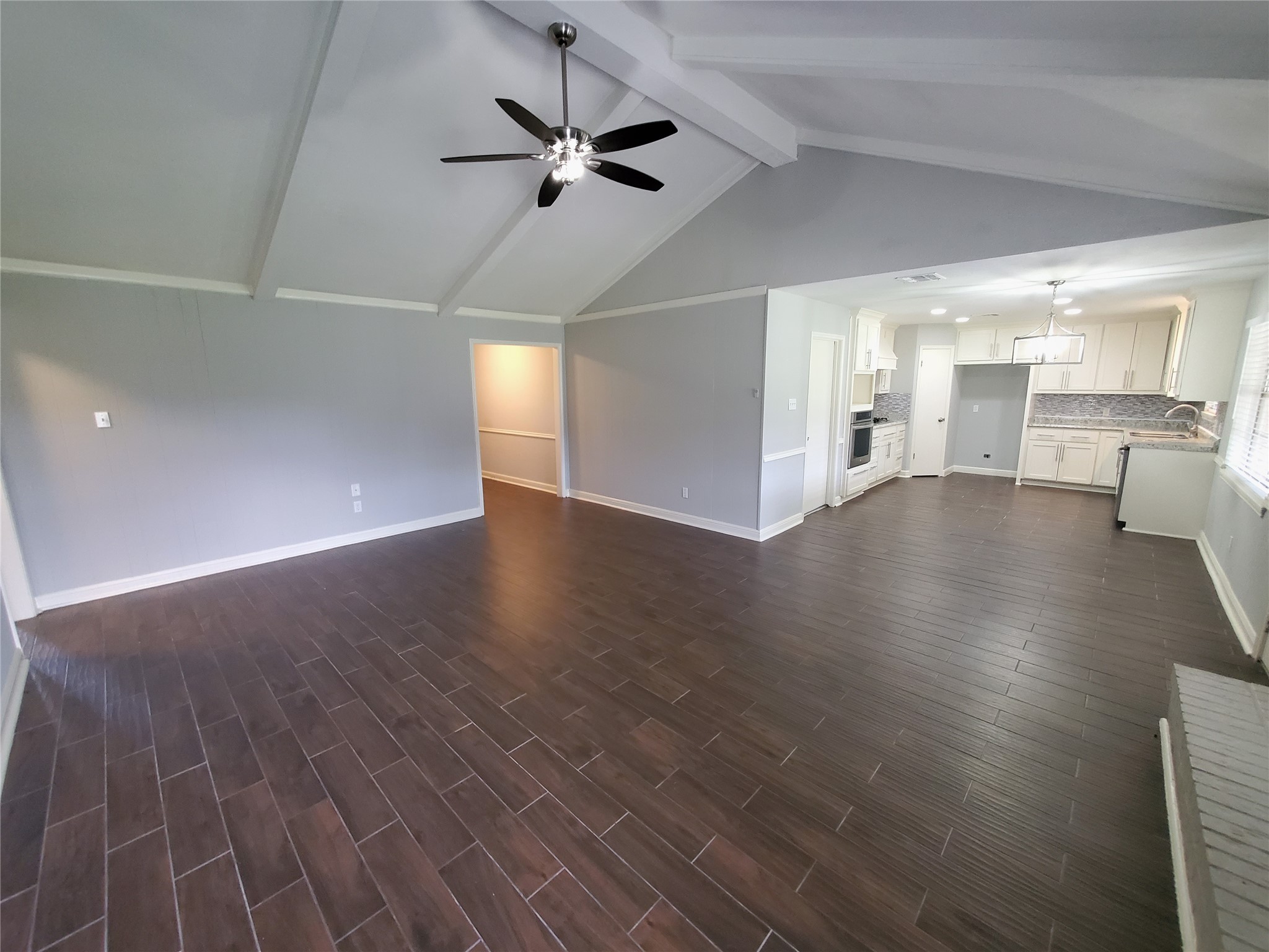 4507 Seneca Street Pasadena, TX 77504 - Photo 5 of 23 an empty room with wooden floor and windows