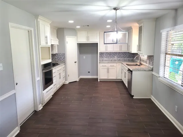 a kitchen with a stove a refrigerator and a sink