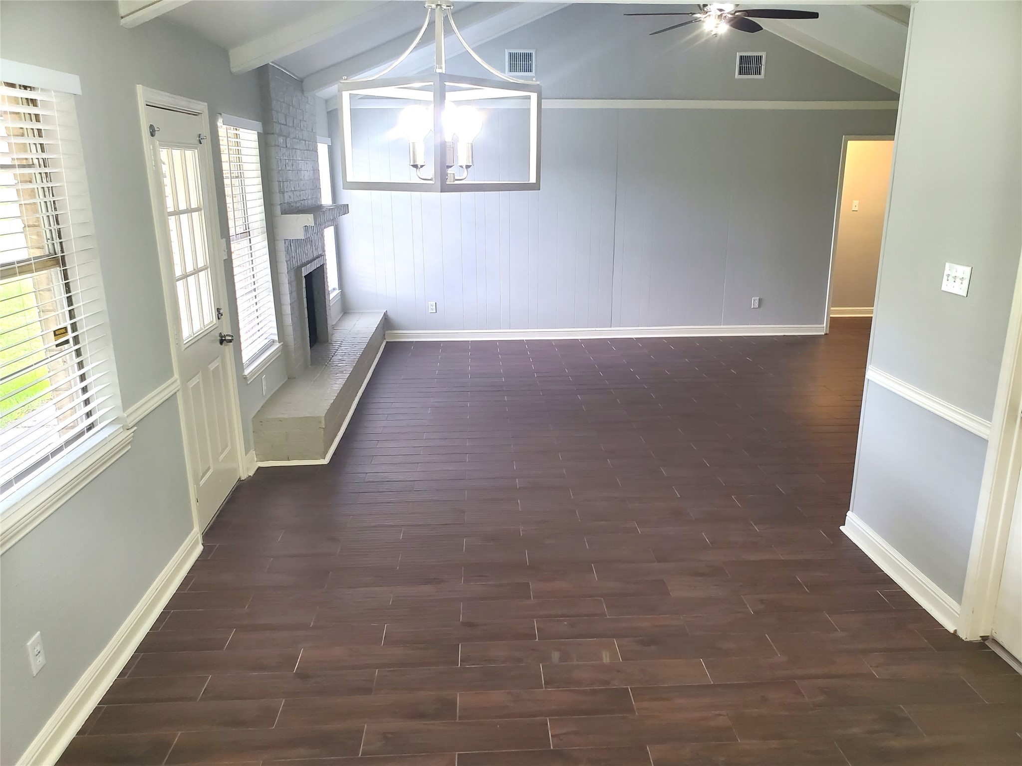 4507 Seneca Street Pasadena, TX 77504 - Photo 9 of 23 a view of a hallway with wooden floor and chandelier