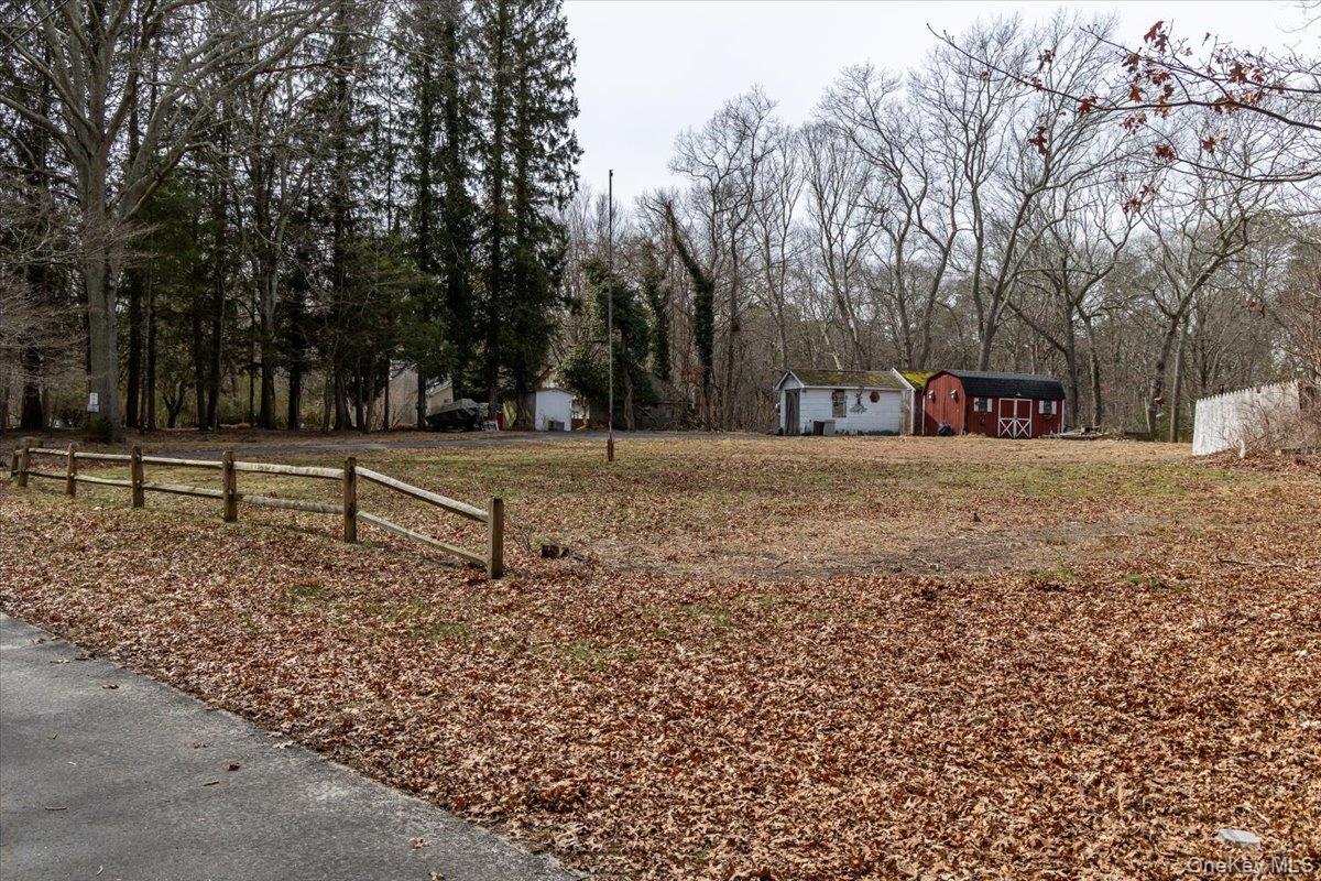 309 Primrose Path Manorville, NY 11949 - Photo 2 of 26 a view of a park with large trees