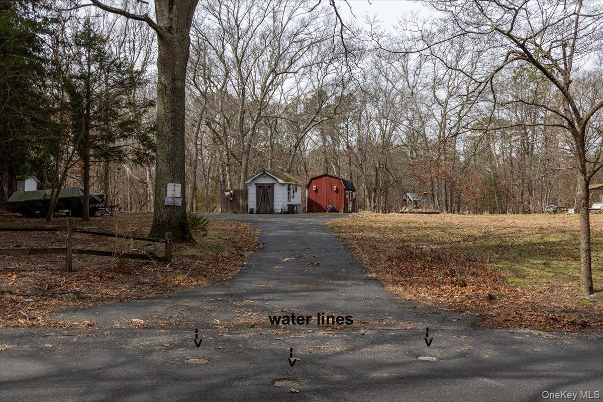 309 Primrose Path Manorville, NY 11949 - Photo 4 of 26 a view of a yard with a house