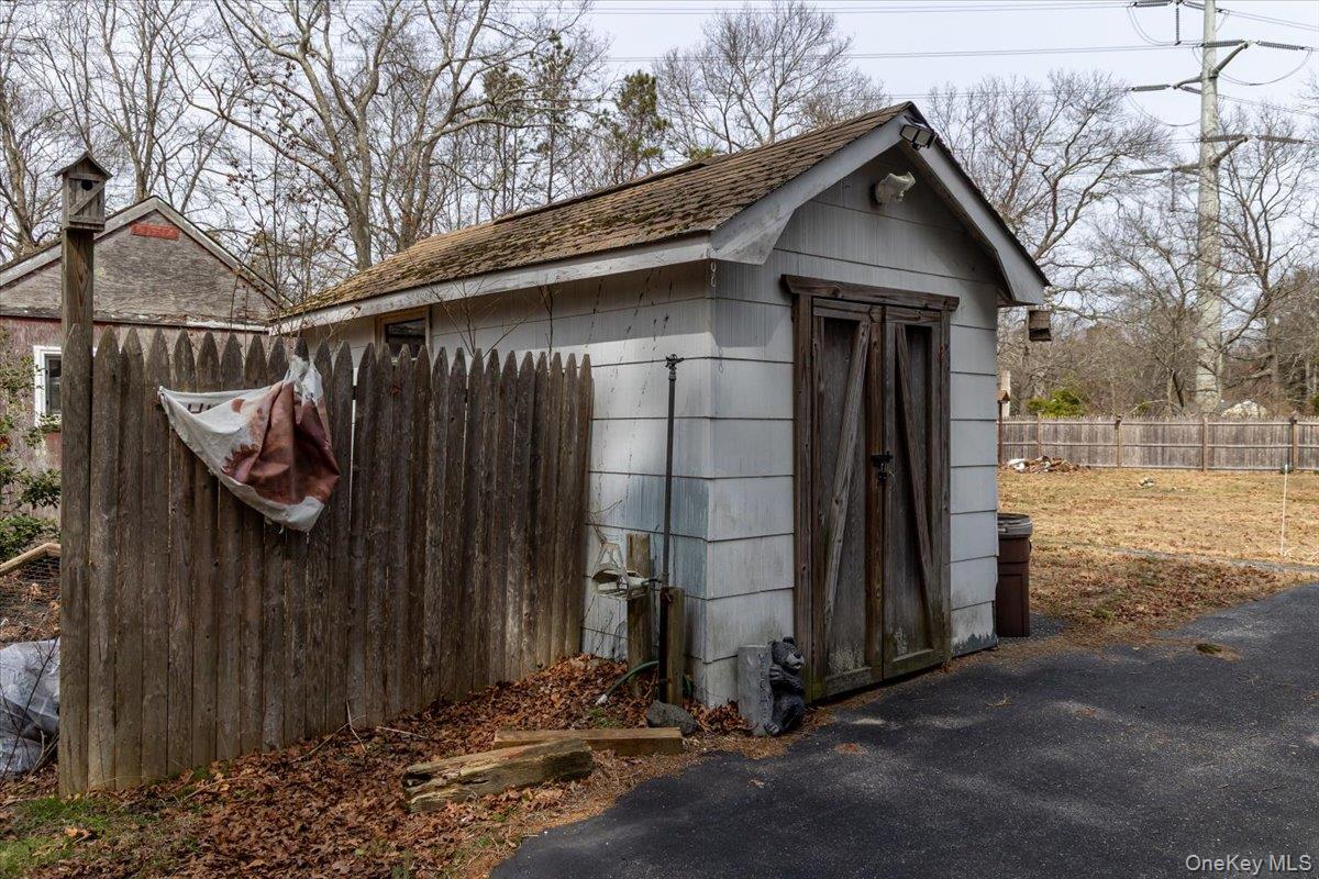 309 Primrose Path Manorville, NY 11949 - Photo 6 of 26 a view of a house with wooden fence