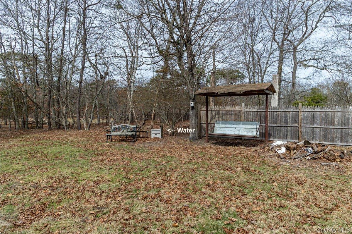 309 Primrose Path Manorville, NY 11949 - Photo 10 of 26 a view of backyard with wooden fence