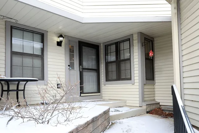 an empty room with windows and fireplace