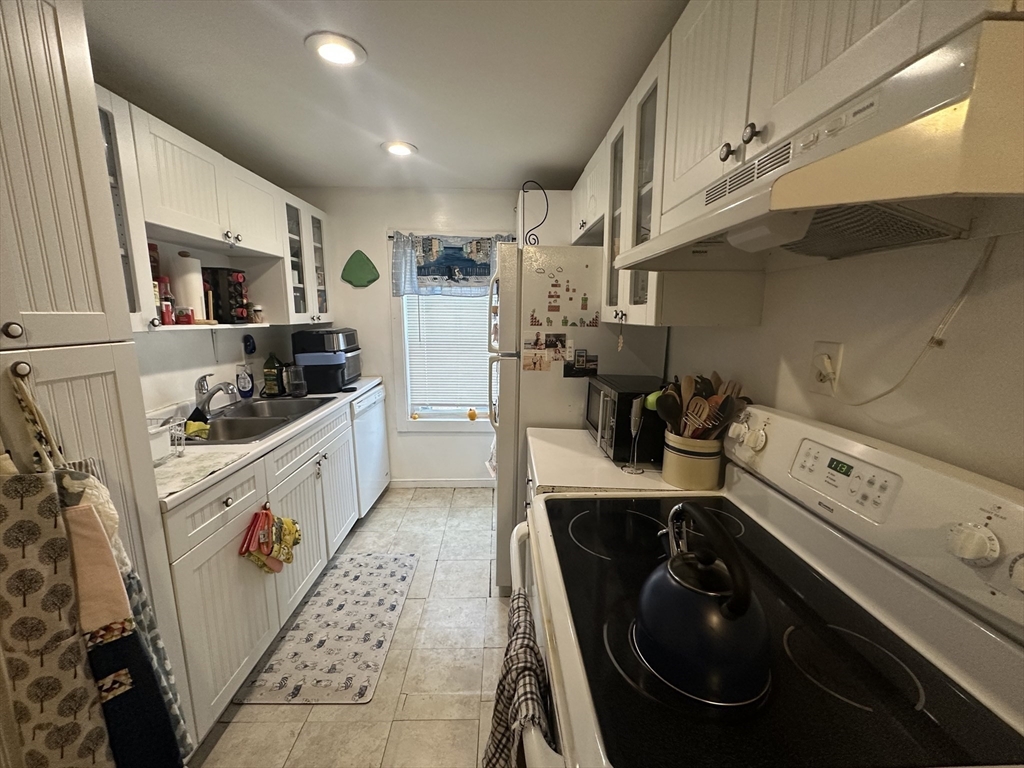 66 Summer Street, Unit 2 Natick, MA 01760 - Photo 11 of 20 a kitchen with a sink a stove and cabinets