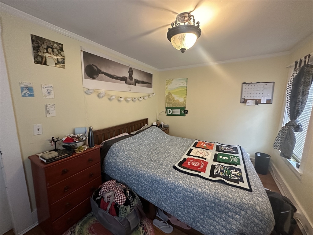 66 Summer Street, Unit 2 Natick, MA 01760 - Photo 13 of 20 a bedroom with bed and a chandelier