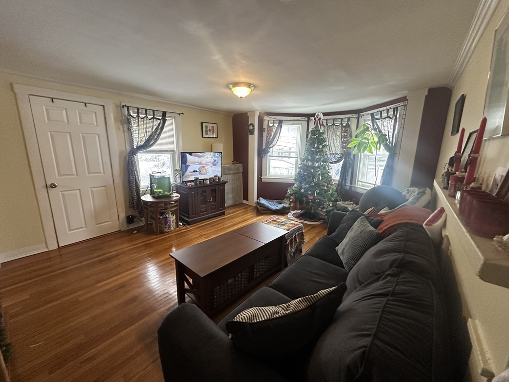 66 Summer Street, Unit 2 Natick, MA 01760 - Photo 6 of 20 a living room with furniture and a flat screen tv