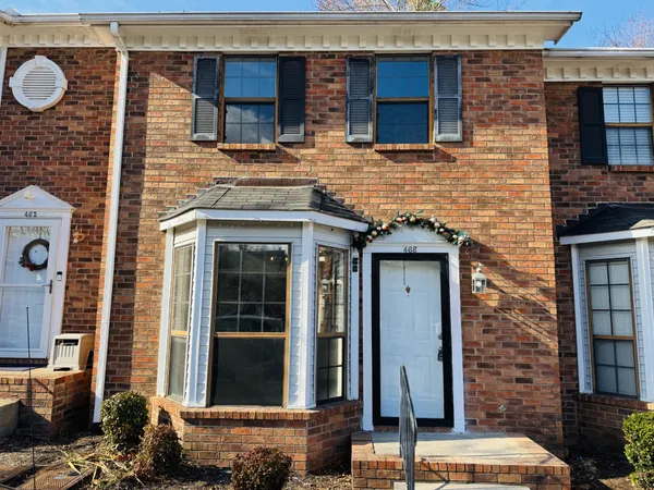 front view of a brick house with a window