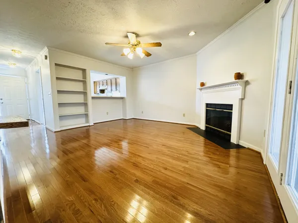 wooden floor in an empty room with a fireplace