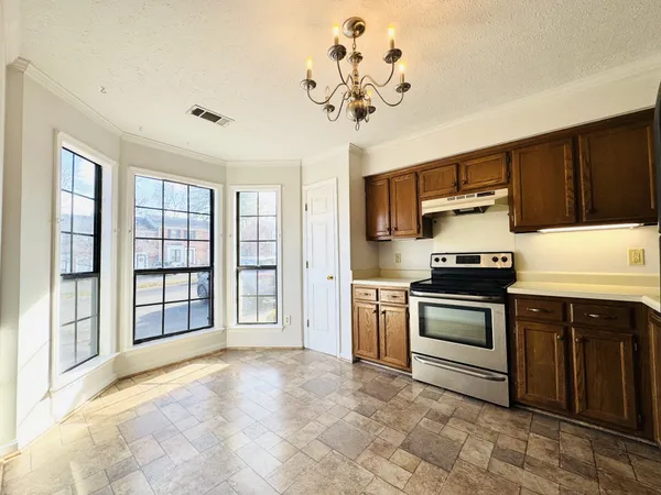 a kitchen with stainless steel appliances granite countertop a stove sink and refrigerator