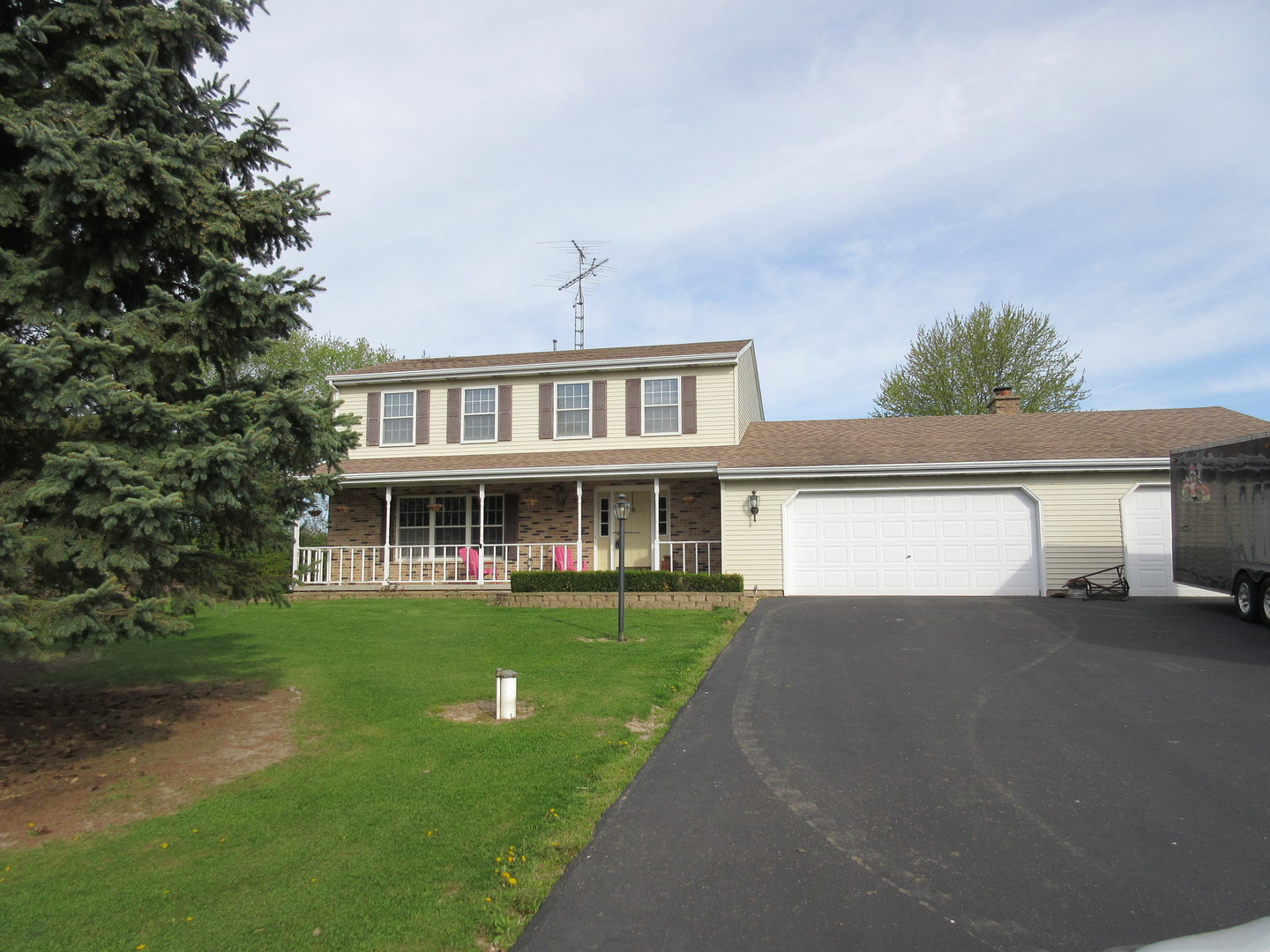 28081 Indian Point Road Sycamore, IL 60178 - Photo 1 of 24 a view of a house next to a big yard and large trees