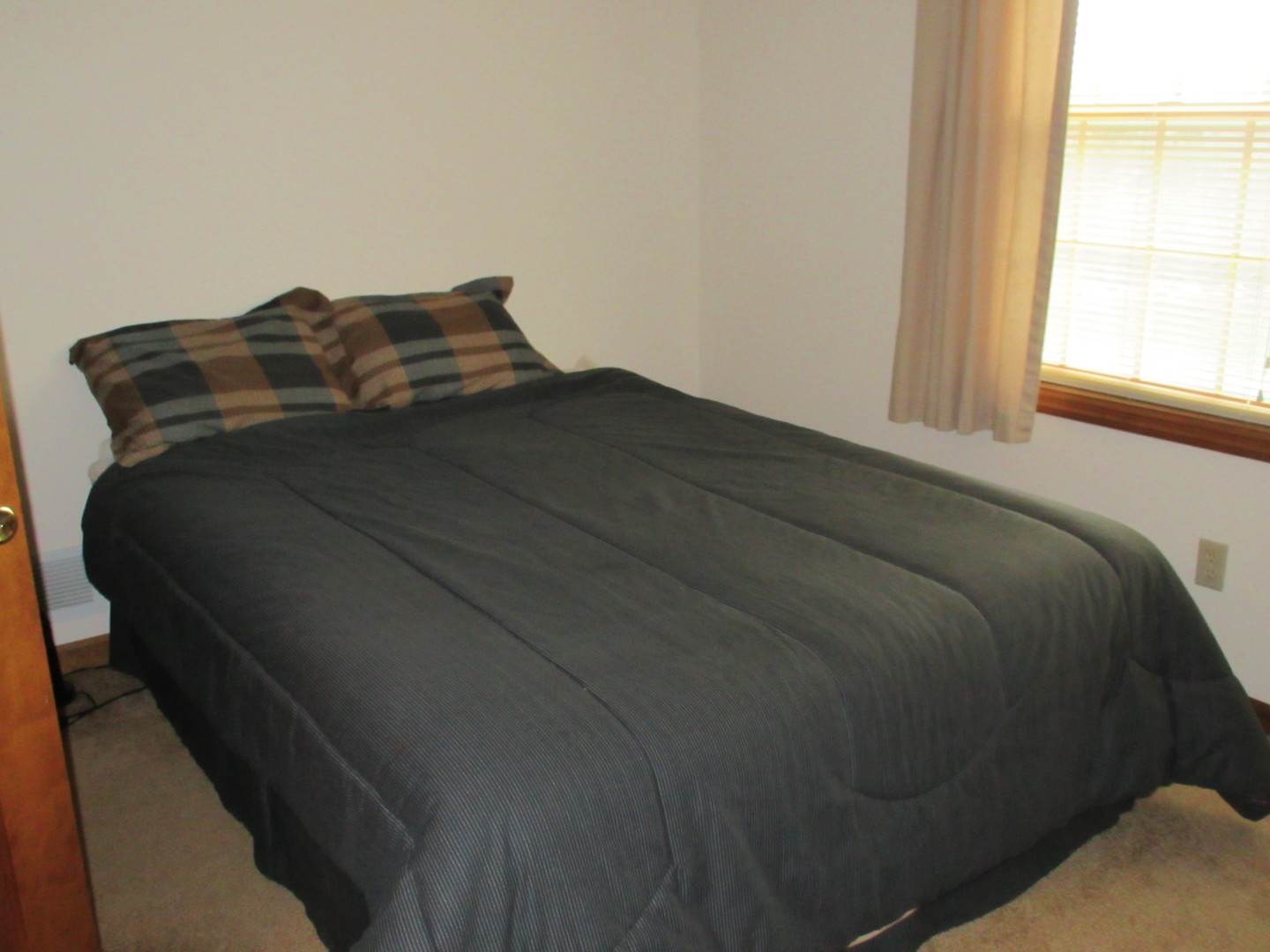 28081 Indian Point Road Sycamore, IL 60178 - Photo 14 of 24 a bed sitting in a bedroom next to a window