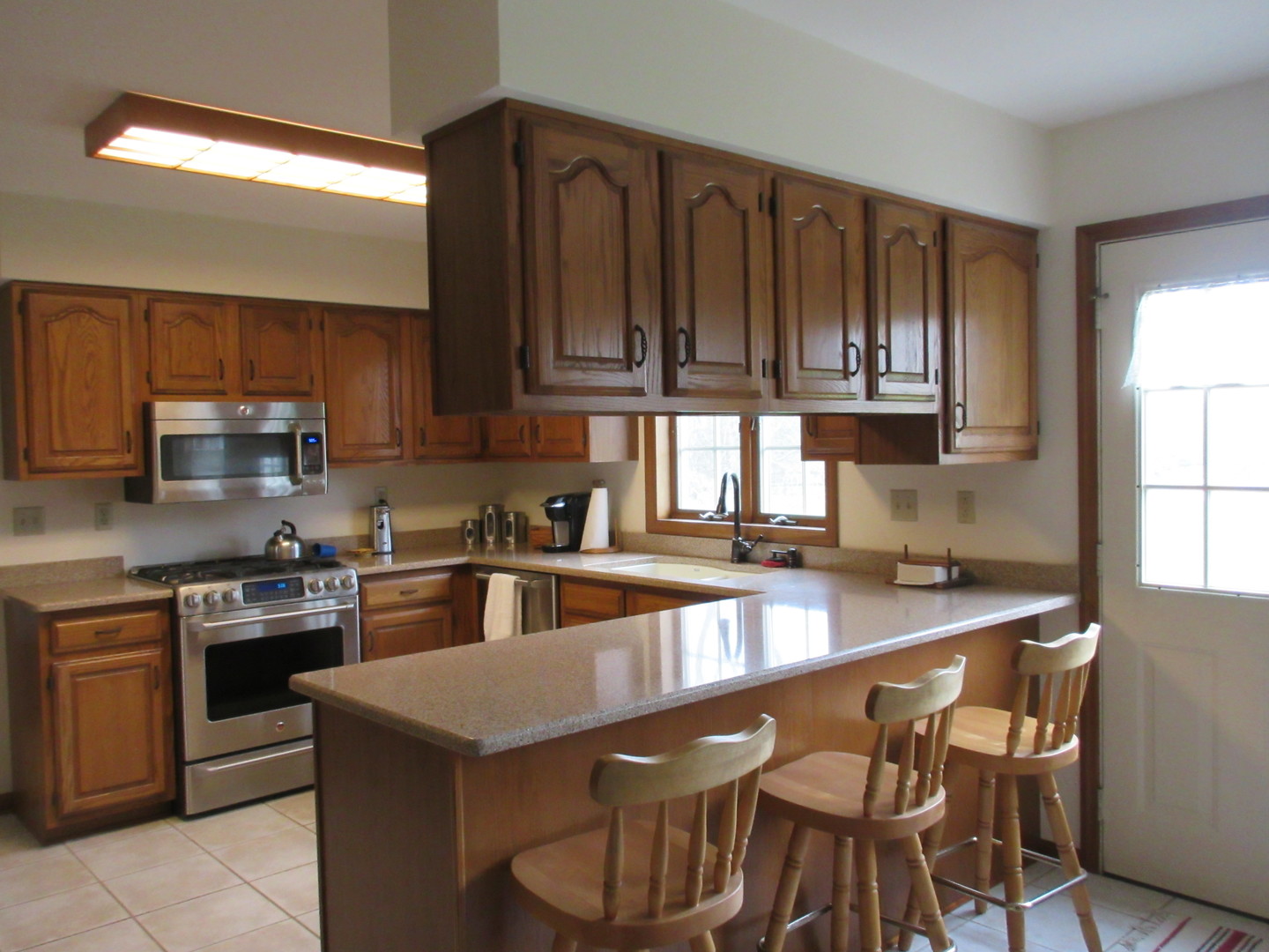 28081 Indian Point Road Sycamore, IL 60178 - Photo 7 of 24 a kitchen with granite countertop wooden cabinets a stove top oven a sink and dishwasher