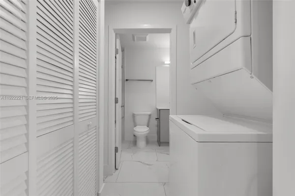 a kitchen with a refrigerator and a stove top oven