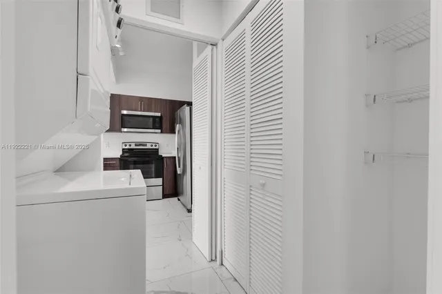 a kitchen with a refrigerator and a stove top oven