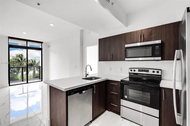 a kitchen with a sink stove and microwave