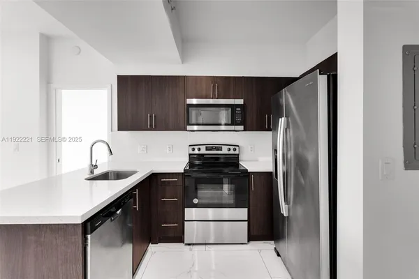 a kitchen with a refrigerator sink and stove