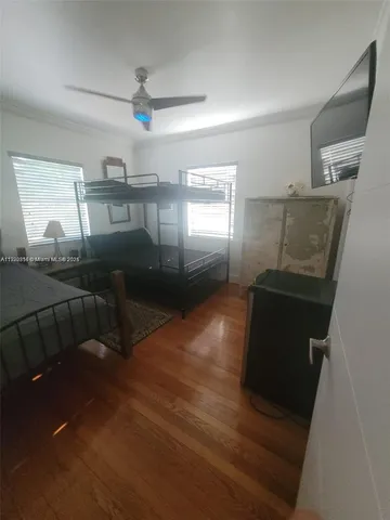 a bedroom with double bed and a window