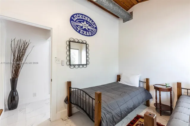 a bedroom with a bed and window