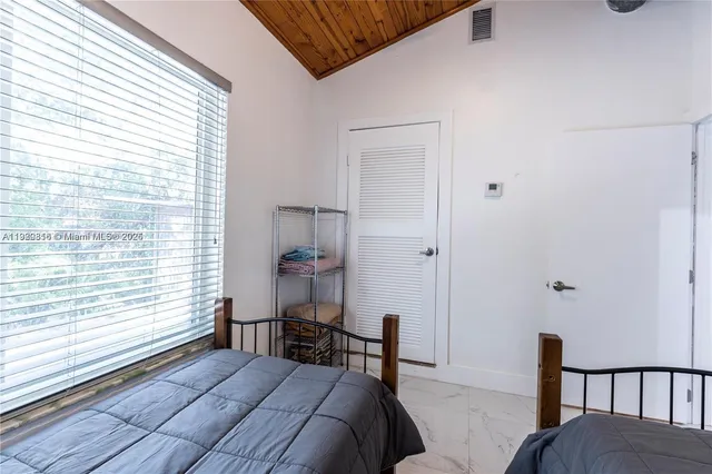 a bedroom with a bed and a television