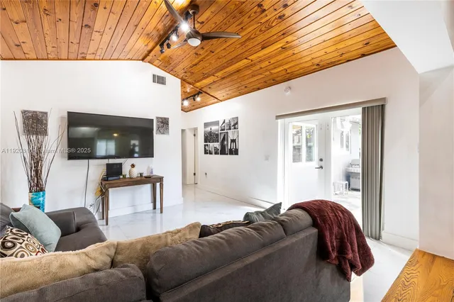 a bathroom with a granite countertop sink mirror toilet and shower