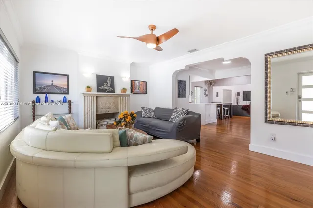a living room with furniture and a wooden floor