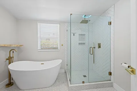 a bathroom with a bathtub and shower