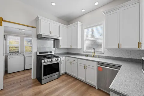 a kitchen with a stove and a sink