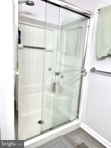 a bathroom with a glass shower door