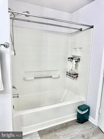 a bathroom with a shower and a bath tub