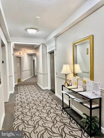 a living room with a couch and a chandelier