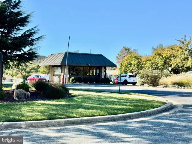 a view of a swimming pool with a table and chairs under an umbrella