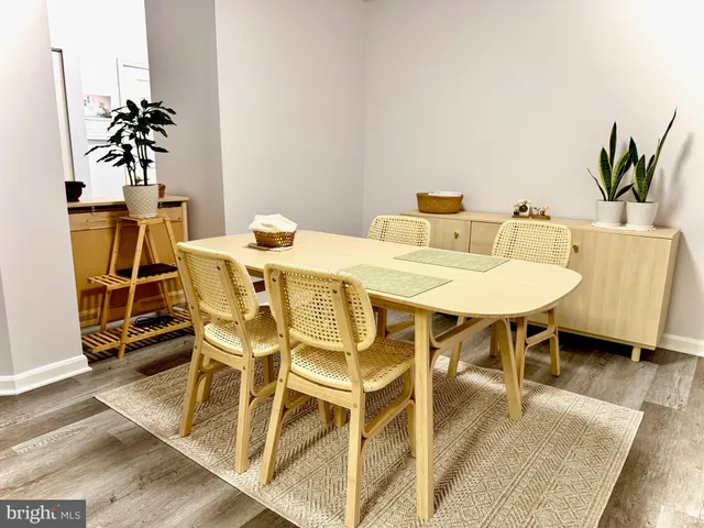 a view of a dining room with furniture and a potted plant