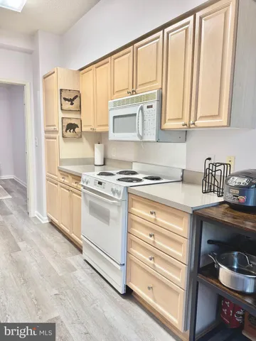 a kitchen with stainless steel appliances granite countertop a stove and a microwave