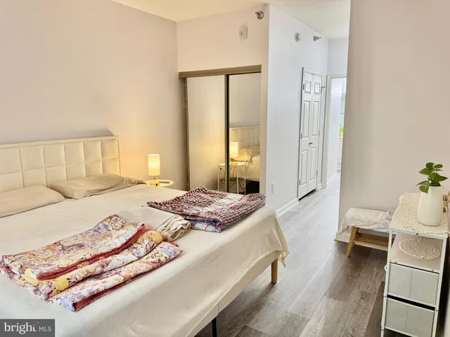 a bedroom with a bed and a mirror