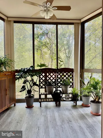 a building outdoor space with patio furniture and potted plants