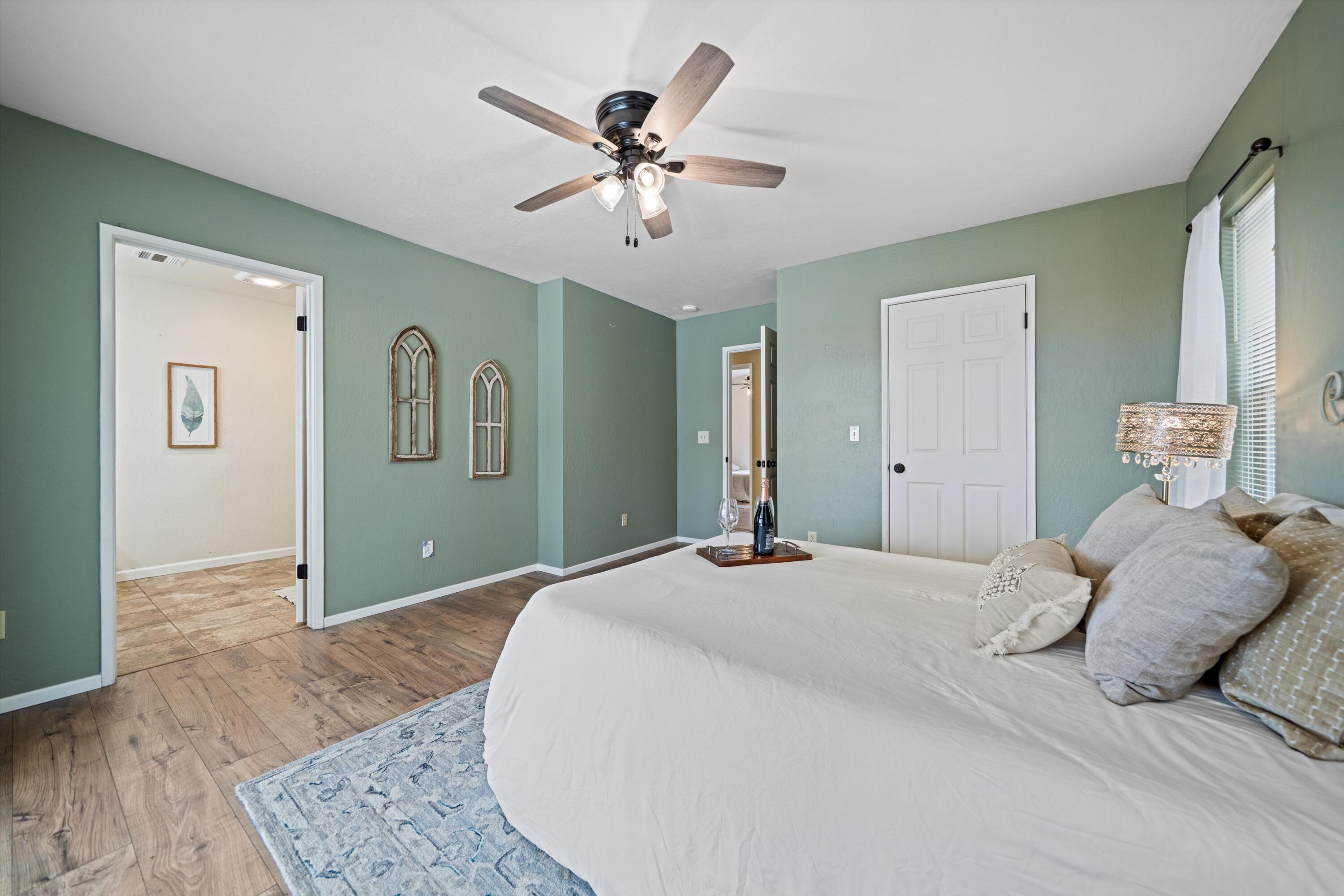 27900 Cummings Valley Road Tehachapi, CA 93561 - Photo 11 of 23 a bedroom with a large bed and a chandelier