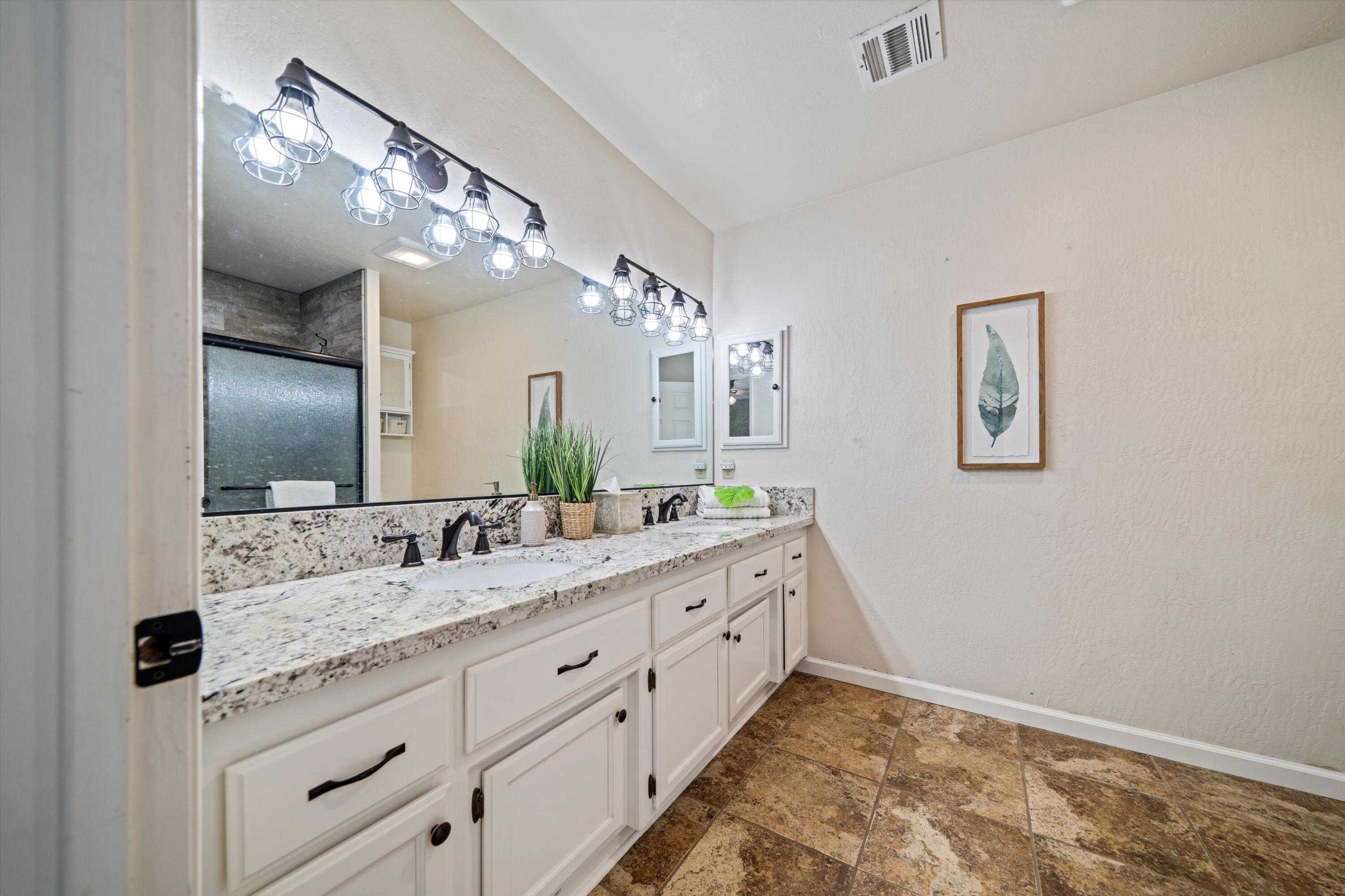 27900 Cummings Valley Road Tehachapi, CA 93561 - Photo 12 of 23 a bathroom with a double vanity sink and a mirror
