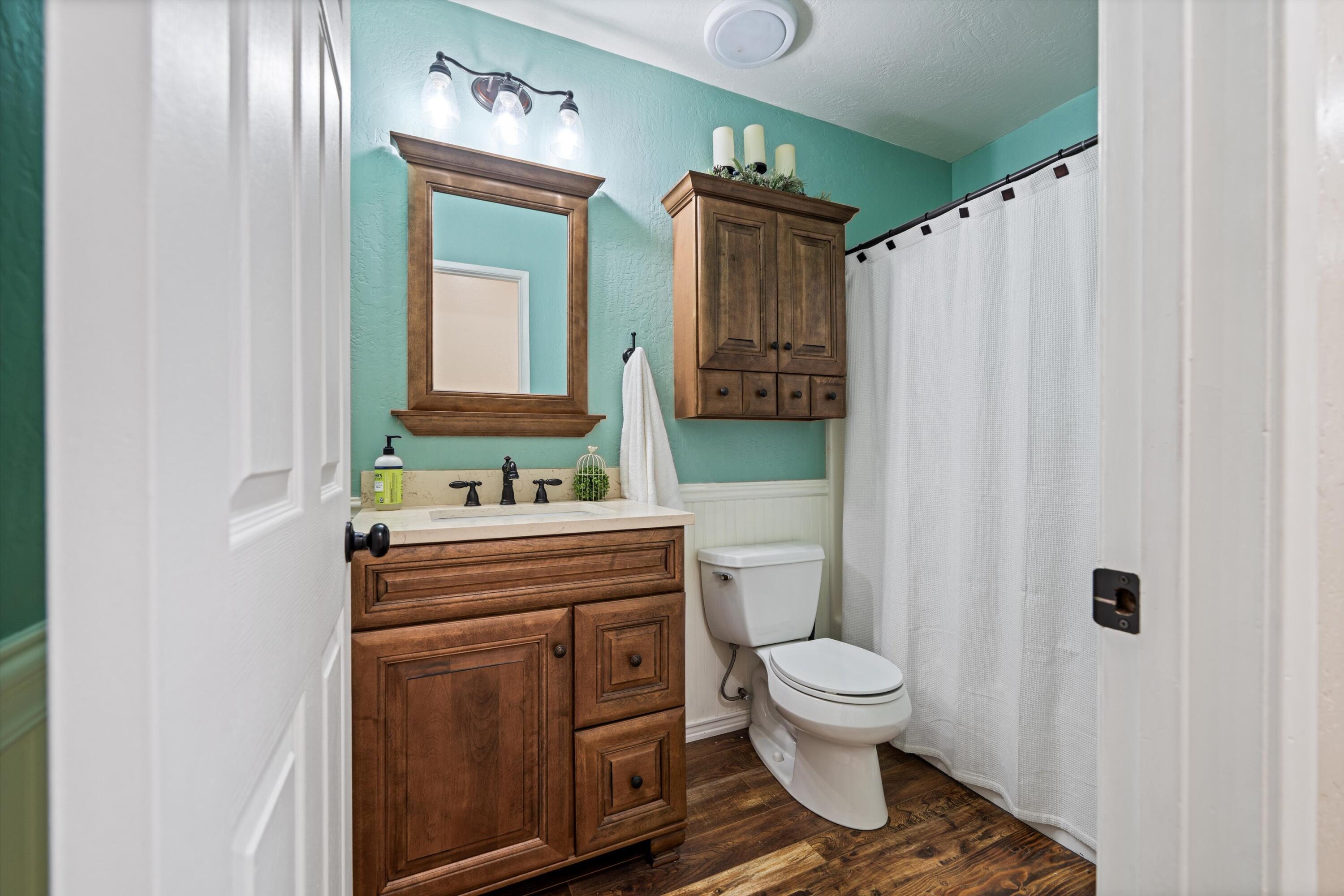 27900 Cummings Valley Road Tehachapi, CA 93561 - Photo 16 of 23 a bathroom with a toilet a sink and a mirror