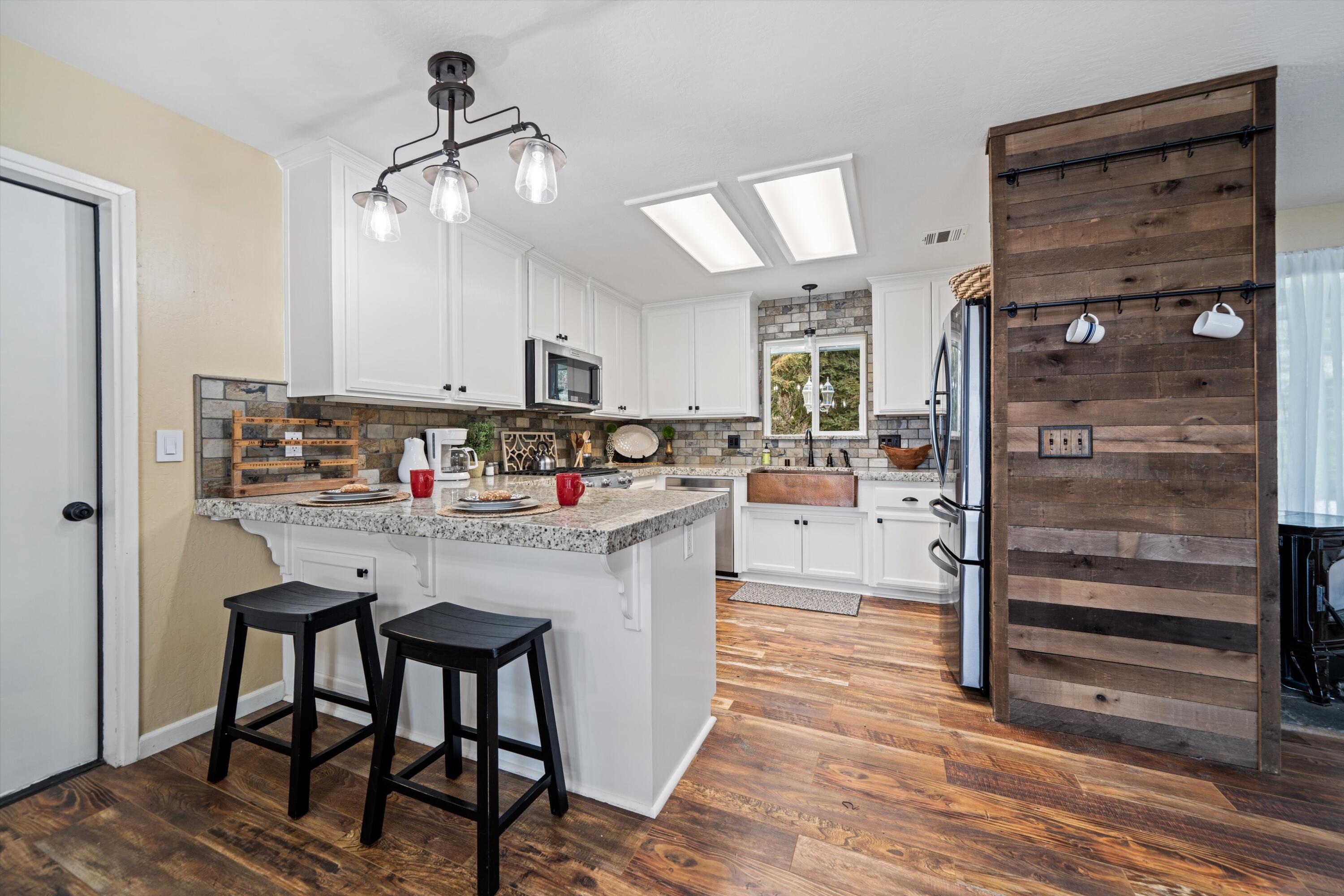 27900 Cummings Valley Road Tehachapi, CA 93561 - Photo 7 of 23 a kitchen with stainless steel appliances granite countertop a refrigerator and a stove top oven
