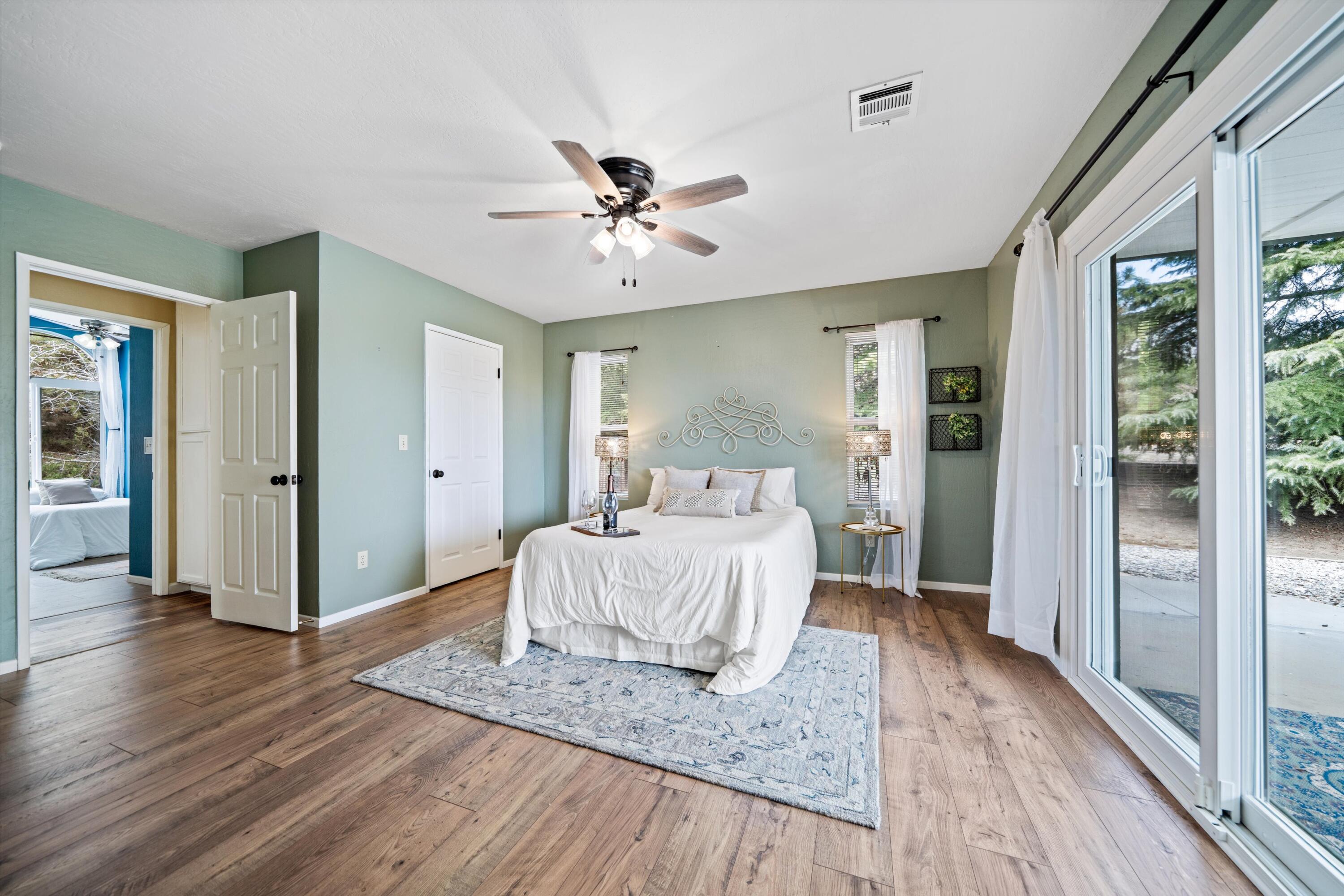 27900 Cummings Valley Road Tehachapi, CA 93561 - Photo 10 of 23 a bedroom with a bed and wooden floor