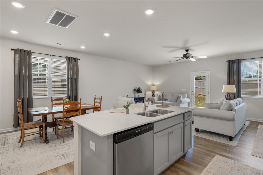432 Bee Cv Way Pendleton, SC 29670 - Photo 13 of 39 An inviting open-concept layout seamlessly connects the kitchen, dining, and living areas.