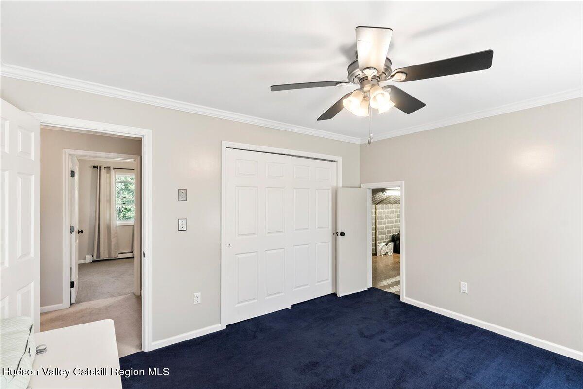 29 Stone Mountain Road Round Top, NY 12473 - Photo 24 of 36 an empty room with closet and a chandelier fan