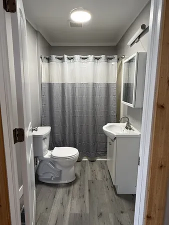 a bathroom with a sink toilet and shower